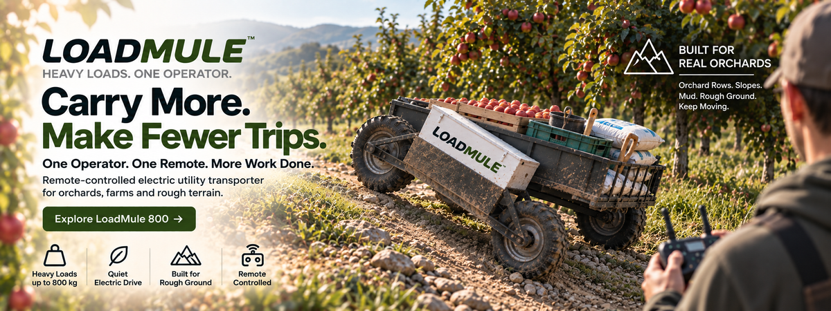 LoadMule 800 electric farm utility cart transporting supplies in an apple orchard
